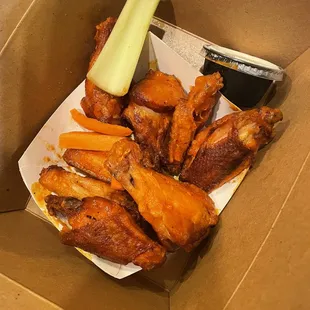 a box of chicken wings and celery