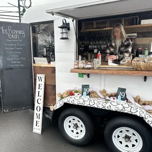 a woman behind a food truck
