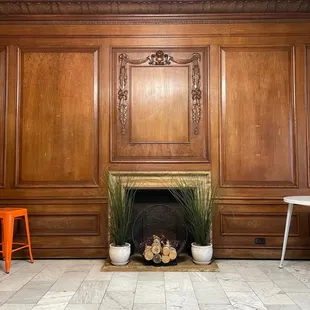 a fireplace in a wood paneled room