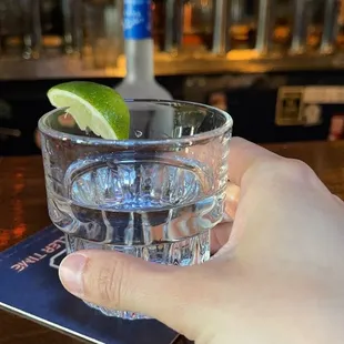 a person holding a glass of water