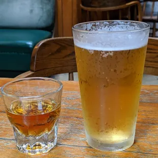 a glass of beer and a glass of whiskey