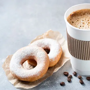 a cup of coffee and two doughnuts
