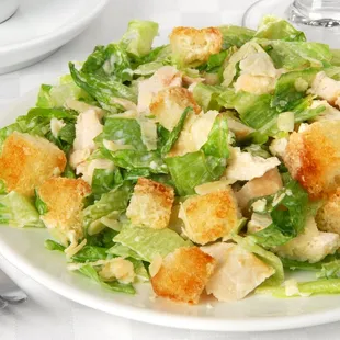 a plate of salad with croutons