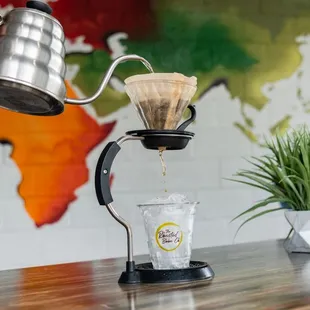 a person pouring a cup of coffee