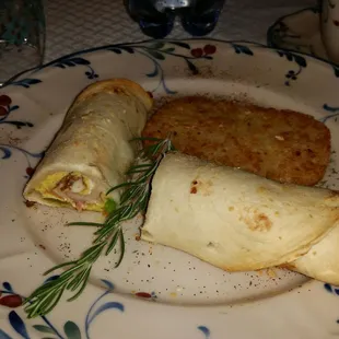&quot;Tusk-en&quot; roll, supposed to resemble elephant tusks. Filled with ham egg cheese onions and a bit of green pepper.