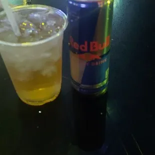 a can of red bull and a drink