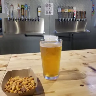 a glass of beer and a snack