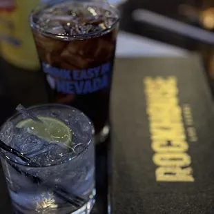 a drink and a book on a table