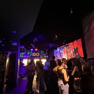 a group of people standing in a dark room