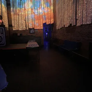 a dark room with a table and chairs