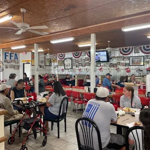 people eating at tables in a restaurant