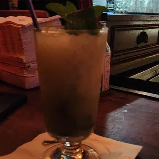 a tall glass of cocktail on a table