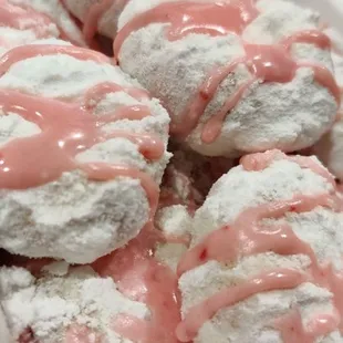 a plate of strawberry cream donuts