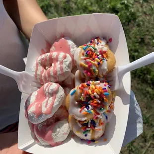 Snow strawberry donuts and birthday cake donuts.