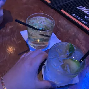 a person holding a glass of alcohol