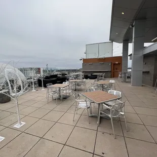 a patio with tables and chairs