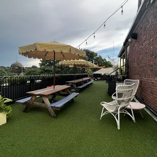 a patio with a table, chairs, and an umbrella