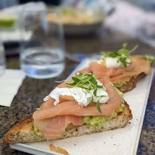 Avocado on toast with poached egg and Salmon