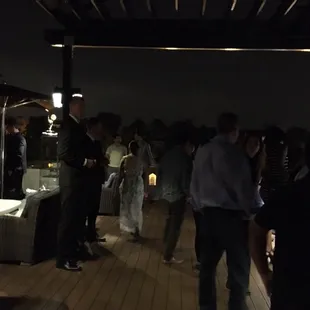 a group of people standing around a table