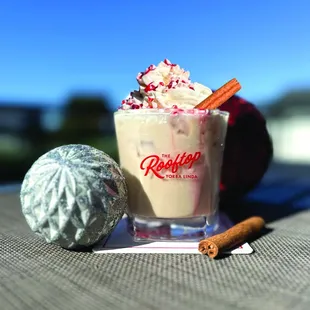 a cup of coffee with whipped cream and cinnamon