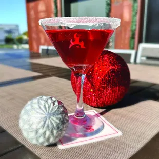 a red cocktail in a martini glass