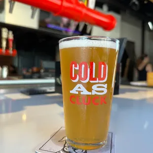 a cold beer in a pint glass