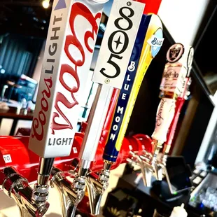 a row of beer taps on a counter