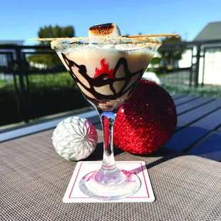 a glass of cocktail on a table