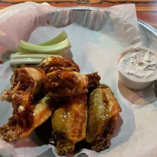 a plate of wings and celery