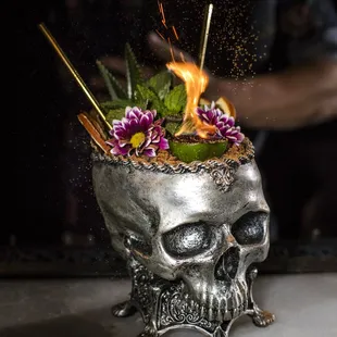 ZOMBIE rr tiki rum blend, donn's mix, falernum, lime, grenadine, angostura, flamed absinthe, served in a skull with flamed cinnamon powder