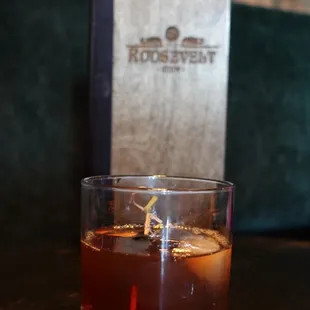 a glass of whiskey on a table