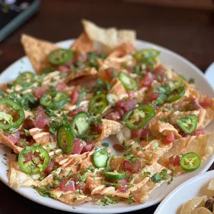 a plate of nachos and a plate of chips