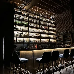 Toward closing time. Very classy, nicely lit bar with library ladder, exposed brick and pipe.