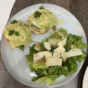 Classic eggs Benedict with side salad freshly shaved Parmesan cheese.