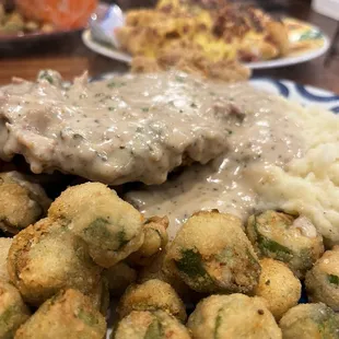 Chicken, fried steak, fried okra, mashed potatoes, and loaded tots.