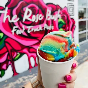 a person holding a cup of ice cream