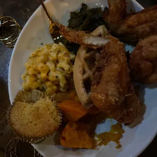 Fried chicken plate with corn bread muffin, greens, sweet potatoes, Mac n cheese w/a waffle