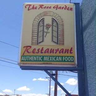 a sign for the rose garden restaurant