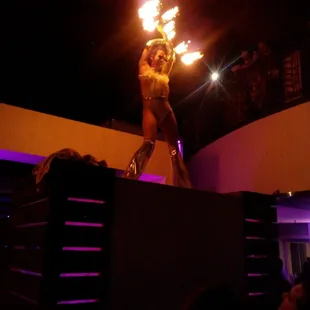 a woman performing with fire
