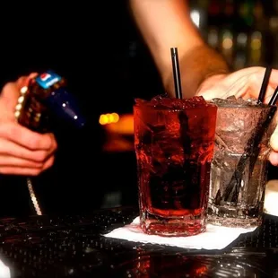a bartender pouring a drink