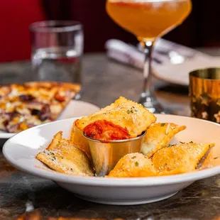 a plate of pizza and a glass of wine