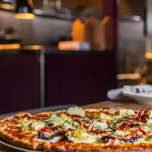 a pizza on a wooden table