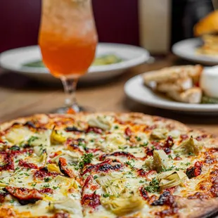 a pizza and a drink on a table