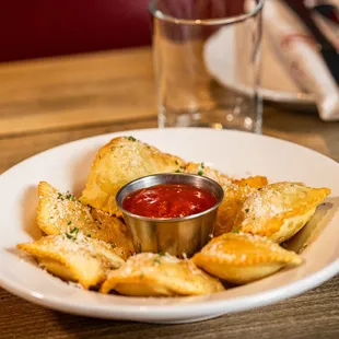 a plate of ravioli and sauce