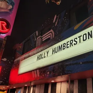 the neon sign for the roxy