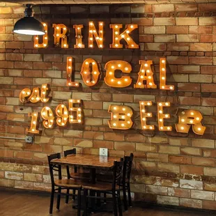 a brick wall with neon signs