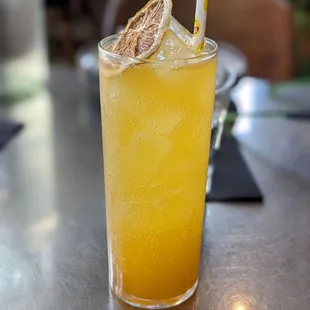 a glass of orange juice on a table