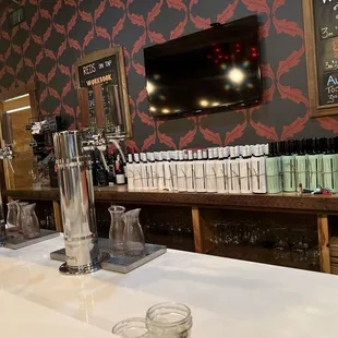 a row of wine glasses on the bar