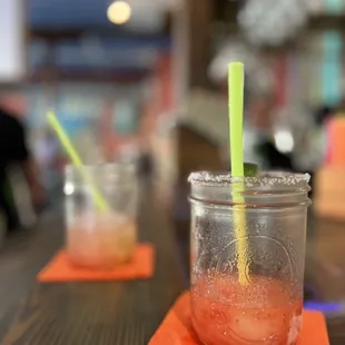 a drink in a mason jar with a straw