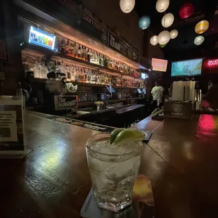 a glass of alcohol on a bar counter